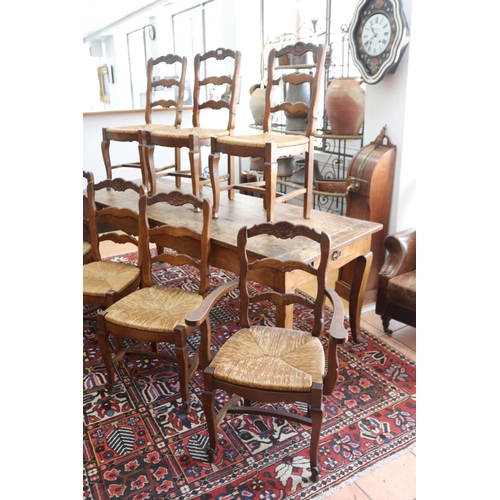 1027 - Set of seven French provincial beech dining chairs to include one elbow chair, each with a shaped la... 