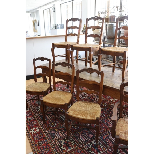 1027 - Set of seven French provincial beech dining chairs to include one elbow chair, each with a shaped la... 