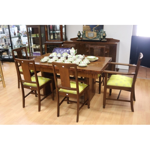 233 - Art Deco walnut dining suite comprising sideboard, six dining chairs & table, with relief carved det... 