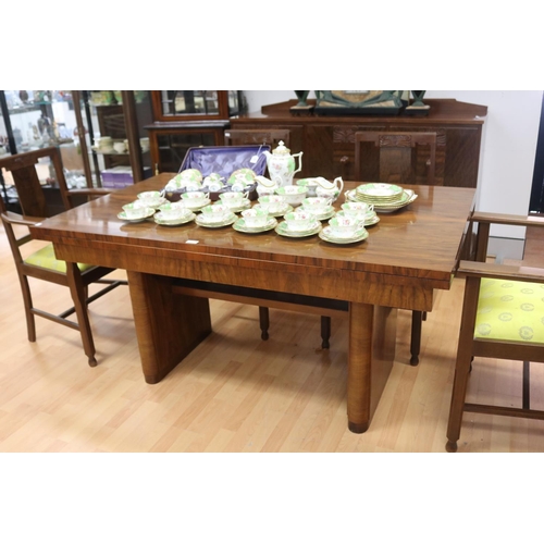 233 - Art Deco walnut dining suite comprising sideboard, six dining chairs & table, with relief carved det... 