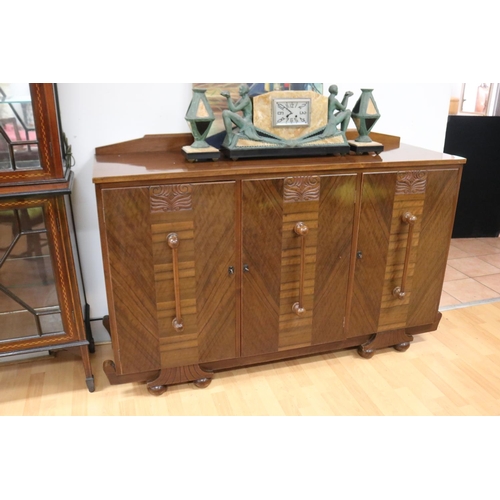 233 - Art Deco walnut dining suite comprising sideboard, six dining chairs & table, with relief carved det... 