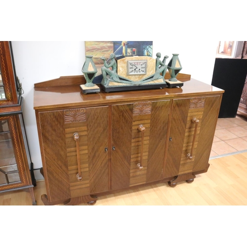 233 - Art Deco walnut dining suite comprising sideboard, six dining chairs & table, with relief carved det... 