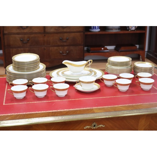 215 - Royal Worcester part dinner service with gilt borders comprising teacups, saucers, breakfast bowls, ... 