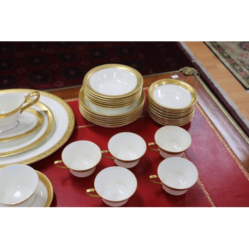 215 - Royal Worcester part dinner service with gilt borders comprising teacups, saucers, breakfast bowls, ... 