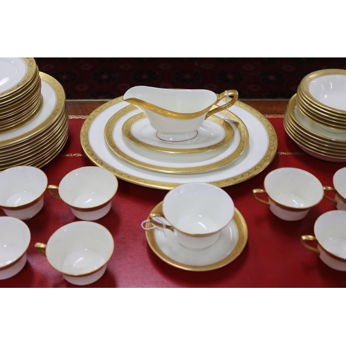 215 - Royal Worcester part dinner service with gilt borders comprising teacups, saucers, breakfast bowls, ... 