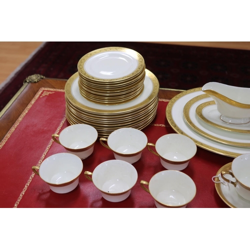 215 - Royal Worcester part dinner service with gilt borders comprising teacups, saucers, breakfast bowls, ... 