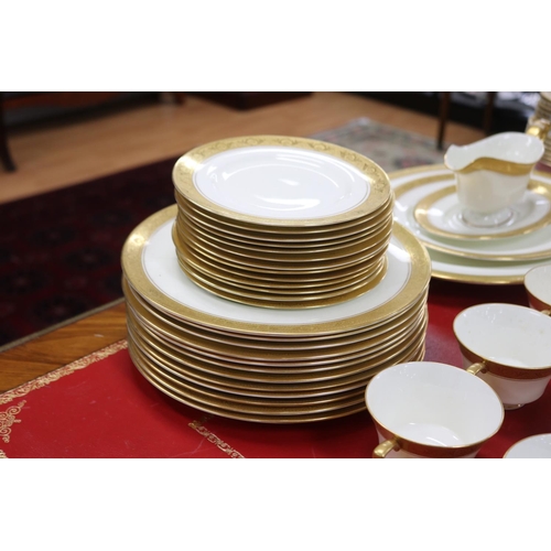 215 - Royal Worcester part dinner service with gilt borders comprising teacups, saucers, breakfast bowls, ... 