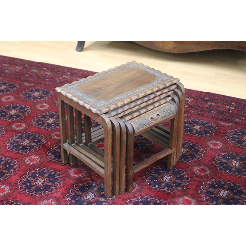 325 - Set of four Indian teak nesting tables with relief carved decoration, approx 38cm H x 46cm W x 29cm ... 