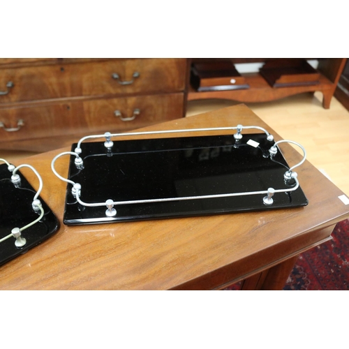 319 - Near pair of chrome & glass drinks trays, approx 45.5cm x 22.5cm & 44cm x 23cm (2)