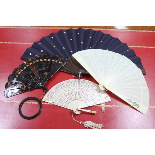 303 - Novelty fan set with a four leaf clover, a tortoiseshell fan, an ivorine fan and an ivory fan with s... 