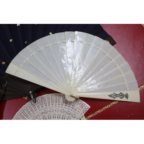 303 - Novelty fan set with a four leaf clover, a tortoiseshell fan, an ivorine fan and an ivory fan with s... 
