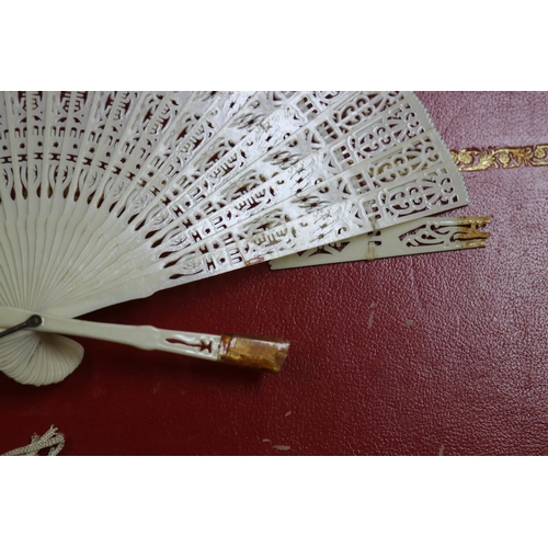 303 - Novelty fan set with a four leaf clover, a tortoiseshell fan, an ivorine fan and an ivory fan with s... 