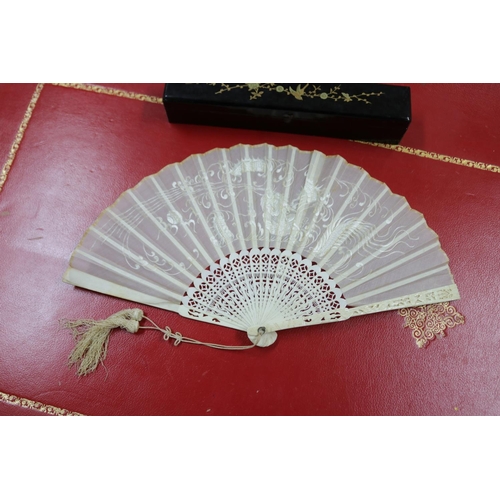 304 - Two Chinese export fans in lacquer cases, one with mother of pearl sticks & the other with pierced b... 