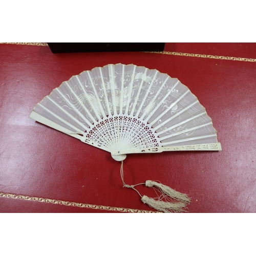 304 - Two Chinese export fans in lacquer cases, one with mother of pearl sticks & the other with pierced b... 