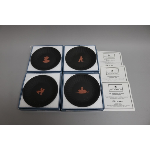 86 - Set of four boxed Wedgwood black basalt Egyptian motif plates, each plate approx 11.5cm Dia (4)