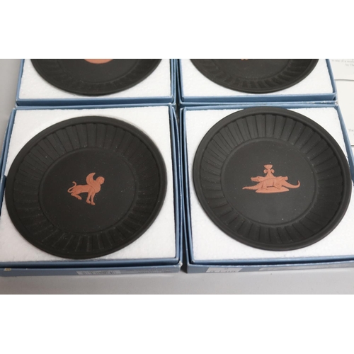 86 - Set of four boxed Wedgwood black basalt Egyptian motif plates, each plate approx 11.5cm Dia (4)