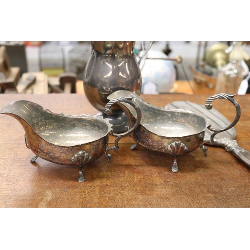 5086 - Pair of silver plate sauce boats, a water pitcher and hand mirror, heavily damaged, approx 35cm L an... 