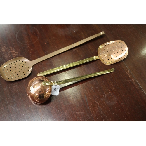 5102 - Three French copper utensils to include two strainers and one scoop, approx 49cm L and shorter (3)