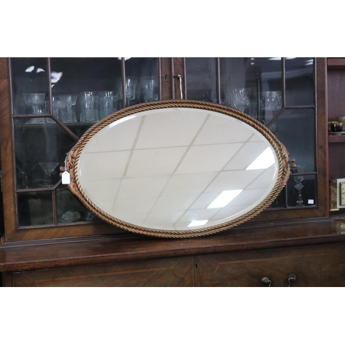 354 - Vintage oval form wall mirror with a rope twist and leaf design, approx 89cm x 51cm