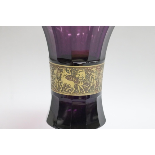 359 - Moser amethyst flared rim pedestal vase with a central brass band collar with figures in low relief,... 