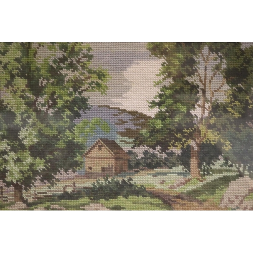 805 - Framed needlework of a cottage in a mountainous scene, approx 31cm x 43cm