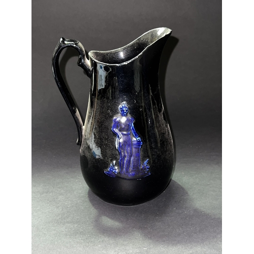 76 - Antique jackfield type jug, cast in relief with a figure  approx 21cm H