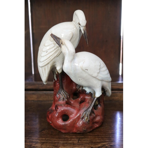 109 - Japanese glazed pottery figure group vase of two cranes (water birds) on a naturalist rouge pierced ... 