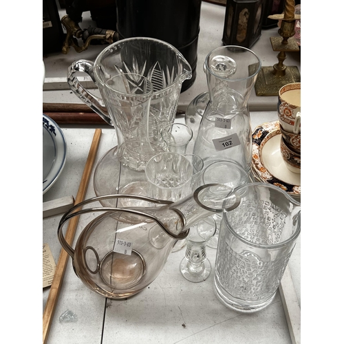 118 - Assortment of glassware. wine carafe, with metal frame, cut crystal jug, approx 26 cm H and smaller.