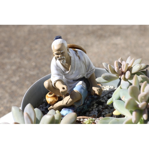 833 - Pot & succulents with oriental man figure, approx 30cm H x 24cm W