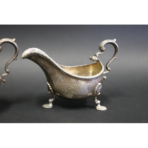 1054 - Pair of antique Scottish silver sauce boats, each with double leaf capped C scroll handles, gadroone... 