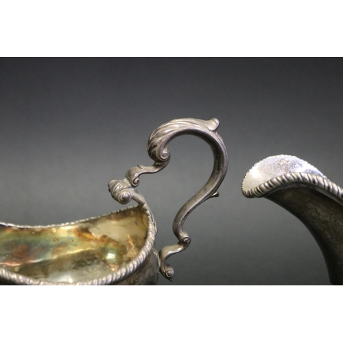 1054 - Pair of antique Scottish silver sauce boats, each with double leaf capped C scroll handles, gadroone... 