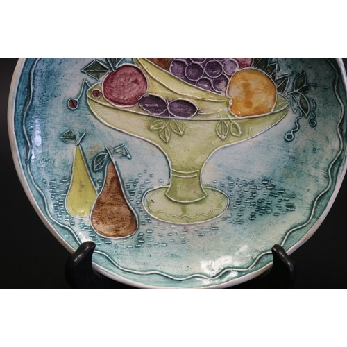 1059 - Francis Jones Studio Sydney, ceramic plate, decorated in raised slip with a comport of fruit, signed... 