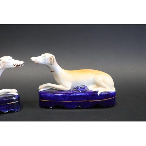 1061 - Pair of Staffordshire pottery recumbent dogs, approx 12cm H x 20cm L each (2)