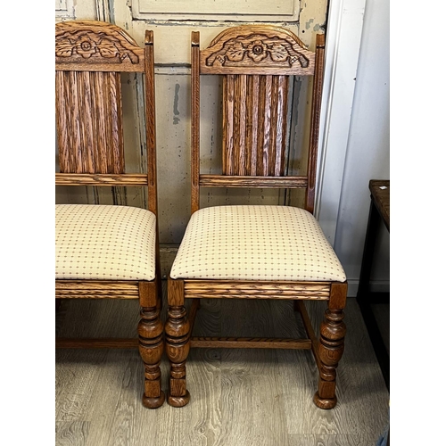 551 - Set of four American Oak turned leg dining chairs, to include one with arms  each with carved decora... 