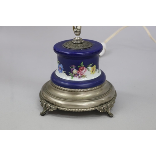 51 - French figural lamp of a putti holding a torch, standing on a porcelain pedestal base, approx 51cm H