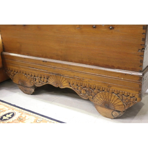 120 - Antique Indian teak Dowry chest, original iron hinges and locks, carry handles to the sides, carved ... 