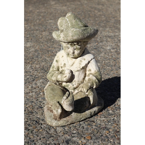 122 - Composite stone garden statue of little boy sitting with apple in hand, approx 31.5cm H