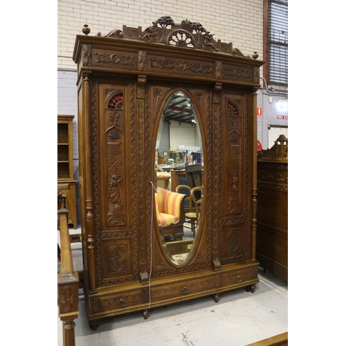 146 - Antique French Brittany three door armoire and three drawers below, carved in relief, approx 246cm H... 