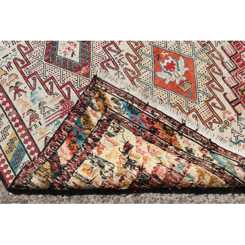 234 - Handwoven wool carpet, multi coloured, geometric design, with birds and animals, approx 190cm x 119c... 