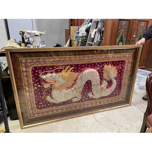 673 - Large Oriental shadow framed tapestry of a Dragon. approx 175 cm W, 101 cm H, 6 cm D.