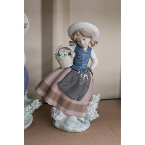18 - Three Lladro figures girls with baskets of flowers, approx 17cm H and shorter (3)
