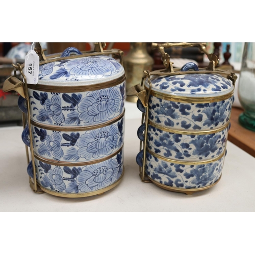 157 - Two Chinese blue and white tiered food containers, with brass carrry handles and frame work, approx ... 