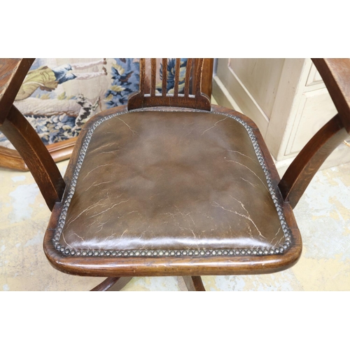 573 - Antique 1920's swivel oak desk chair. studded brown leather seat