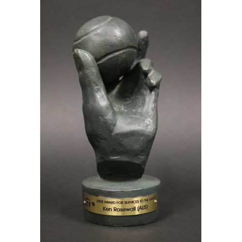 1322 - Award. LAURENCE BRODERICK (B.1935), British. Hand & tennis ball, signed verso. Plaque reads ITF 2008... 