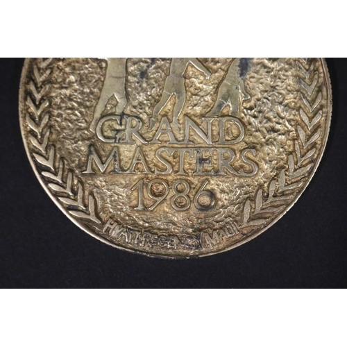 1292 - Tennis trophy medal. GRAND MASTERS 1986 HYATT REGENCY MAUI. Inscribed B.Vienna MAUI SS. Approx 7.5cm... 