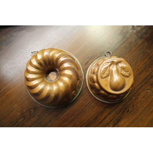 1 - Two vintage copper molds, one with a pear pattern, approx 10cm H x 23cm Dia and smaller  (2)