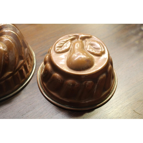 1 - Two vintage copper molds, one with a pear pattern, approx 10cm H x 23cm Dia and smaller  (2)