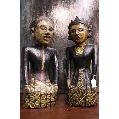 38 - Pair of carved hard wood South East Asian male and female figures, painted decoration, showing age, ... 