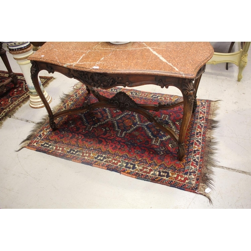 214 - Tribal hand knotted wool carpet, of red ground, approx 117cm x 185cm