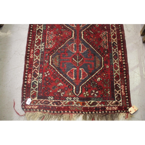 242 - Hand woven tribal wool carpet, two central guls, approx 81cm x 138cm